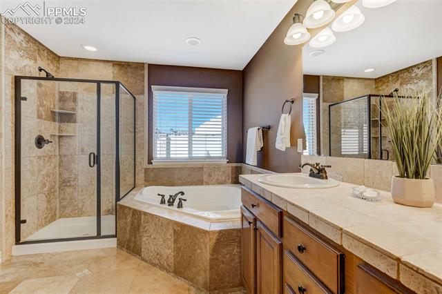 1415 Diamond Rim Drive Colorado Springs, CO 80921 - Photo 5 of 13 Bathroom with tile floors, separate shower and tub, and oversized vanity