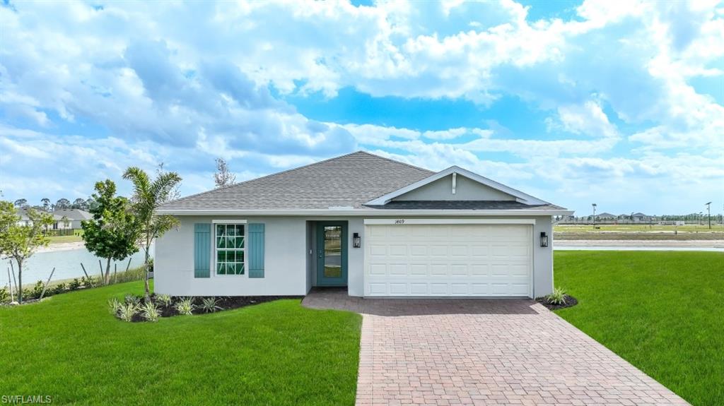 5007 3rd Street West Lehigh Acres, FL 33971 - Photo 1 of 24 Model Home. This property features a single-story residence with a light gray exterior, a gray shingle roof, and a white garage door