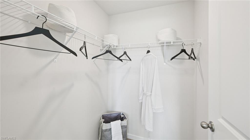 5007 3rd Street West Lehigh Acres, FL 33971 - Photo 13 of 24 Model Home. Closet with white wire shelving and hanging rods
