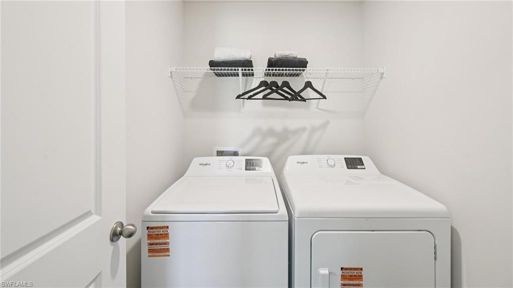 5007 3rd Street West Lehigh Acres, FL 33971 - Photo 16 of 24 Model Home. Dedicated laundry area featuring a washer and dryer, along with a wall-mounted wire shelf for storage