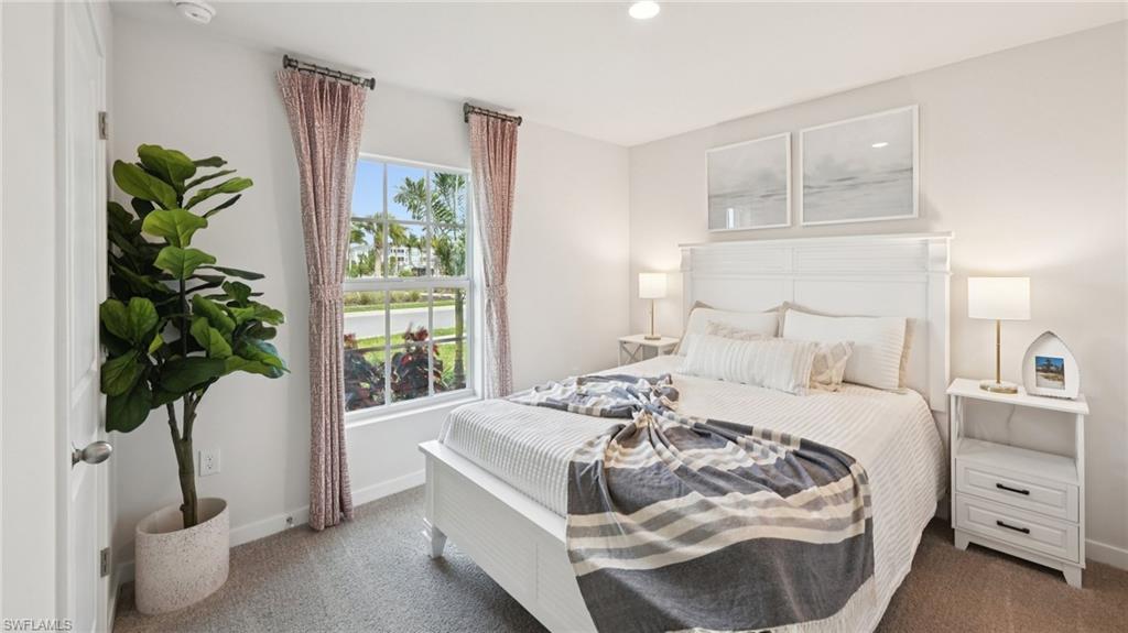 5007 3rd Street West Lehigh Acres, FL 33971 - Photo 19 of 24 Model Home. This bedroom features light-colored walls, carpeted flooring, and a window with curtains
