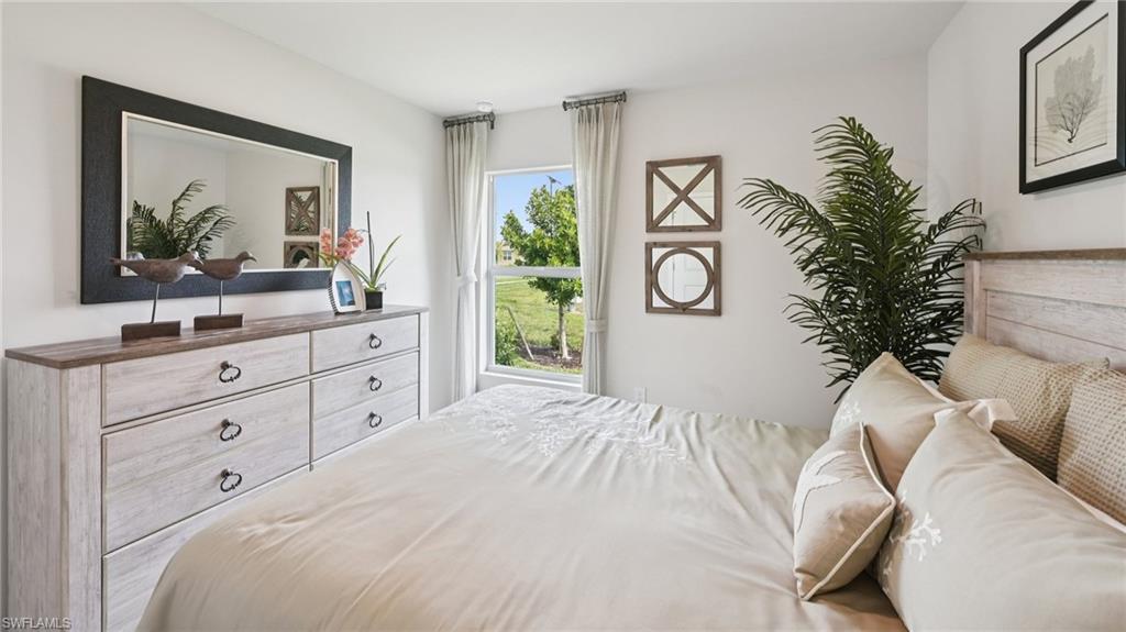 5007 3rd Street West Lehigh Acres, FL 33971 - Photo 22 of 24 Model Home. This bedroom features a window providing natural light and views of green landscaping