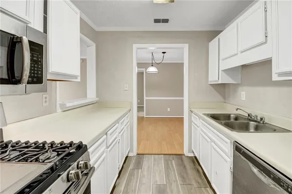 a kitchen with a sink and a stove top oven