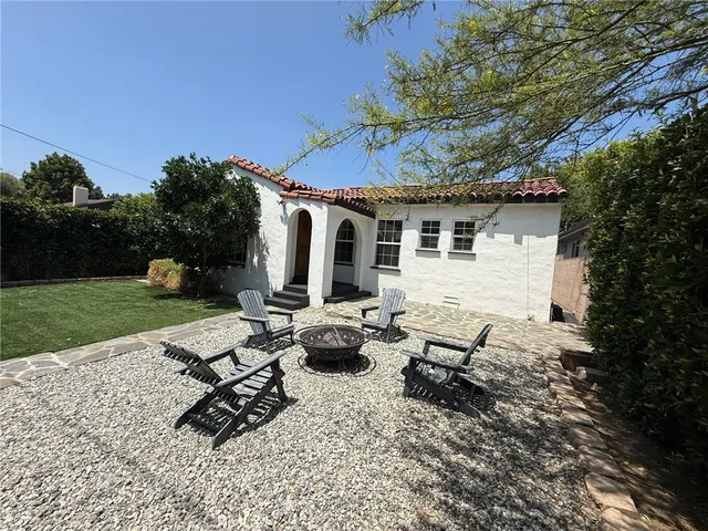 a view of a backyard with sitting area