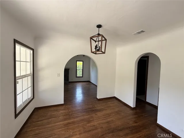 a view interior of a house with wooden floor chandelier and windows