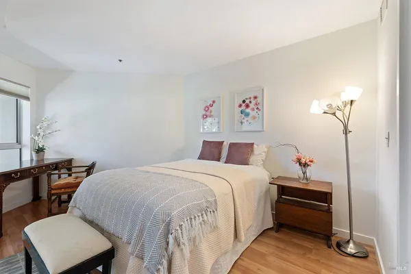 a bedroom with a bed and a table
