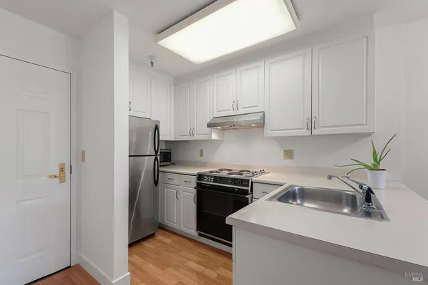 a kitchen with a sink cabinets and stainless steel appliances