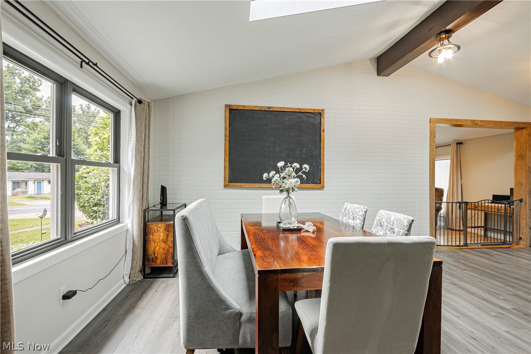 9315 Price Road Ravenna, OH 44266 - Photo 2 of 31 Dining room featuring plenty of natural light, light hardwood / wood-style flooring, and lofted ceiling with skylight