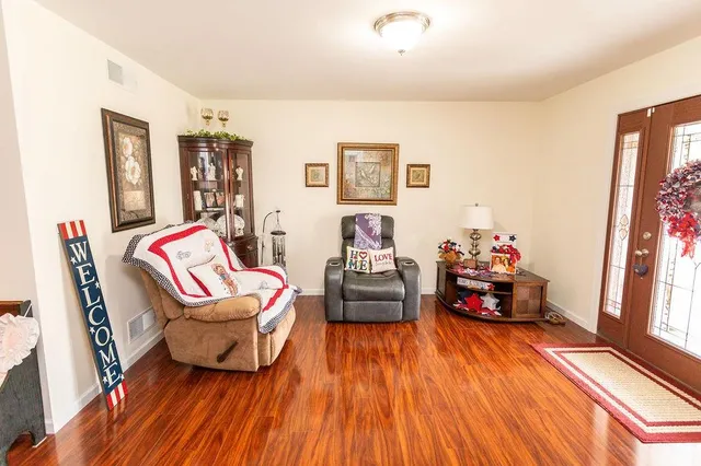a bedroom with furniture and a wooden floor