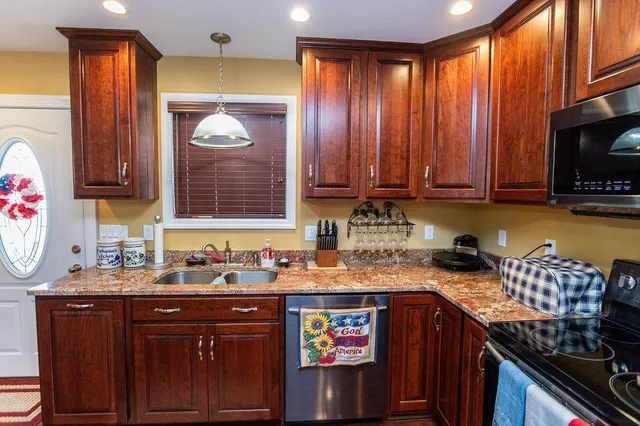 a kitchen with a sink a stove and a microwave