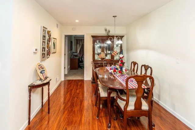 a view of a dining room with furniture and chandelier