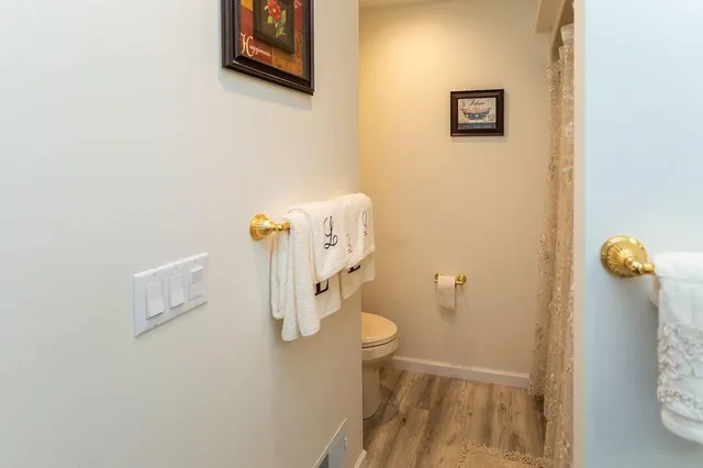 a bathroom with a toilet and a shower