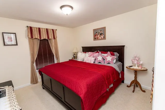 a bed room with a bed and a chair