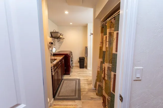 a view of a hallway with a livingroom and a entryway