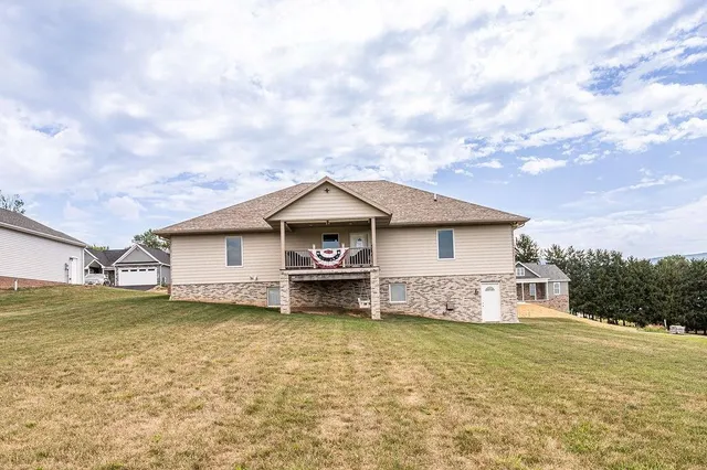 a house that has a big yard and a large tree