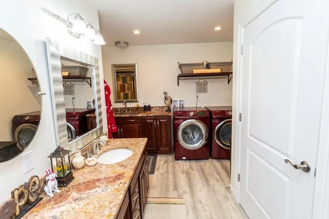 a utility room with sink dryer and washer