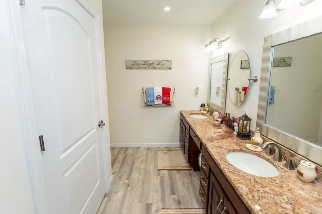 a bathroom with double vanity sink and a mirror