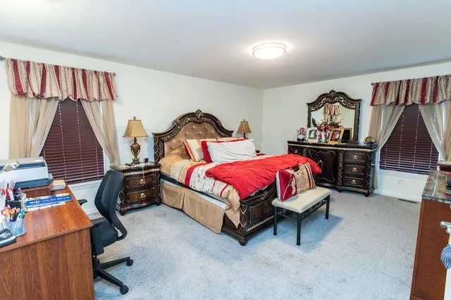 a bedroom with a bed and a night stand