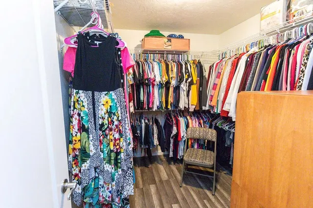 a view of walk in closet with clothes