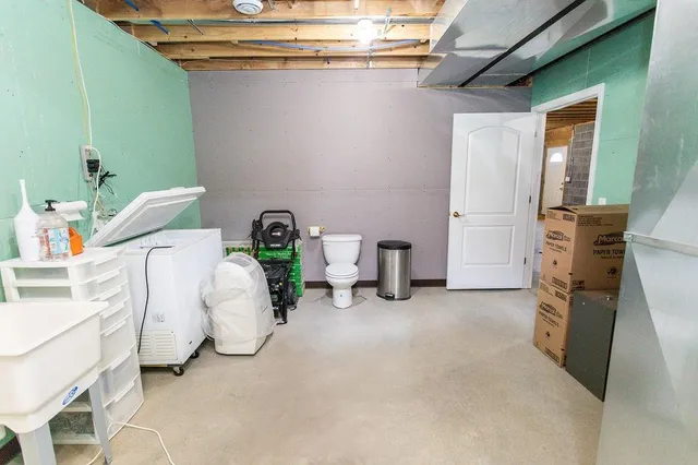 a bed room with a bed and a chair