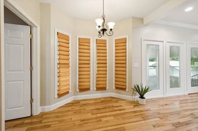 a view of a room with wooden floor and windows