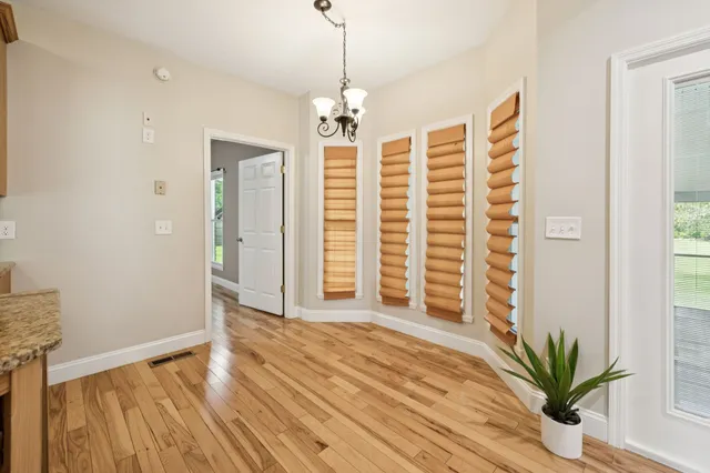 a kitchen with granite countertop a sink a stove and cabinets