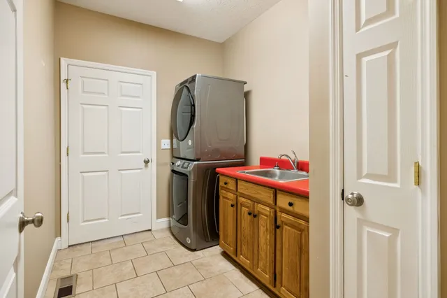 an empty room with wooden floor and a ceiling fan