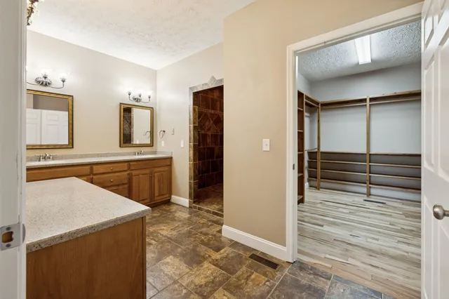 a bathroom with a granite countertop sink a vanity and a mirror