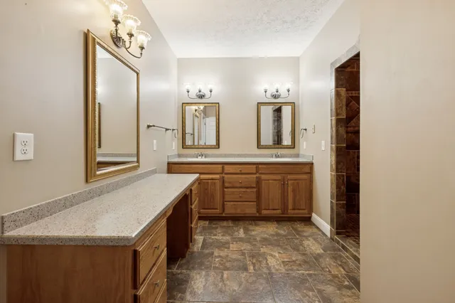 a bathroom with a double vanity sink and a mirror