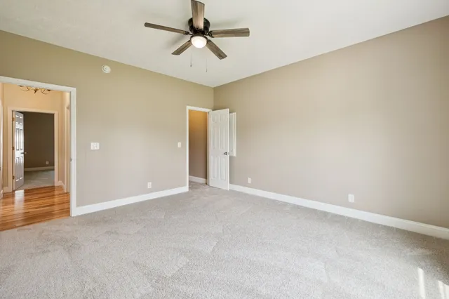 a view of a livingroom with a window and a ceiling fan