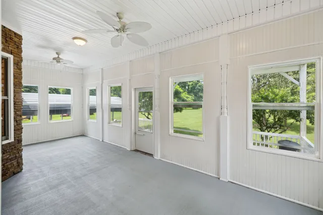 a view of hallway with living room and a window