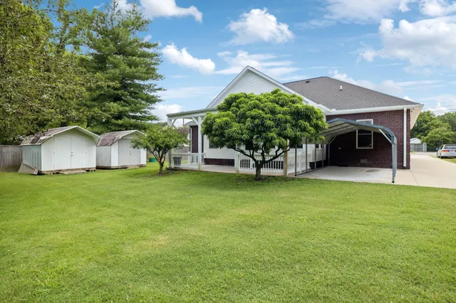 a front view of a house with a garden