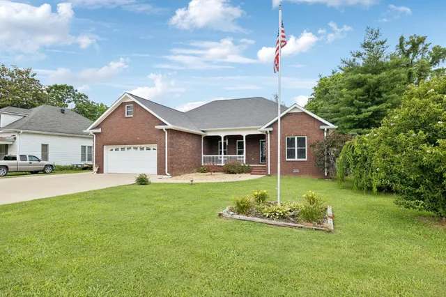 a view of a house with a yard porch and sitting area