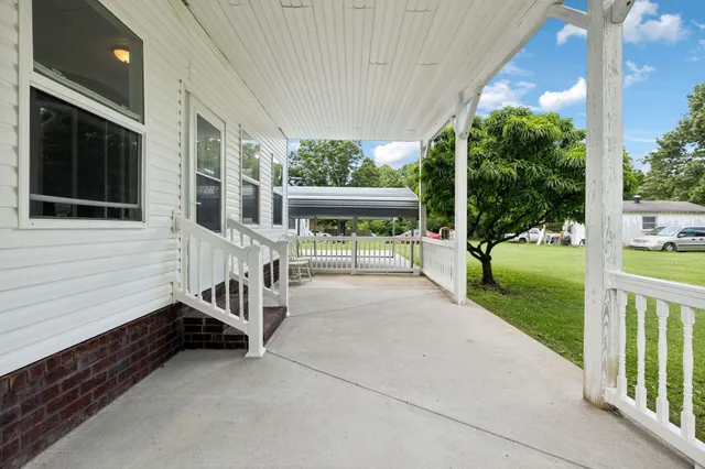 a view of a house with backyard and porch
