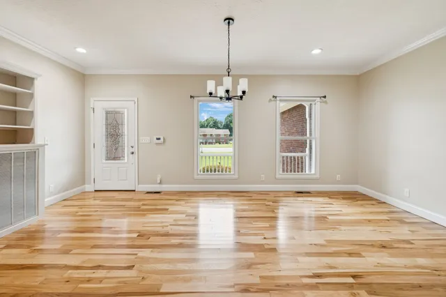a view of a room with a window and chandelier