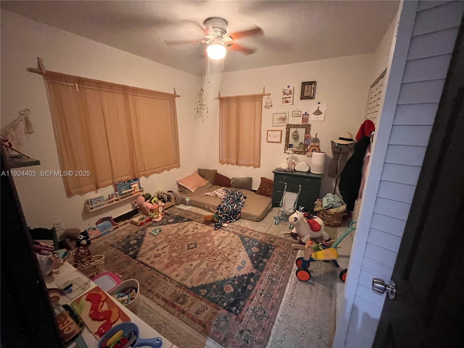 55 Northwest 44th Street Miami, FL 33127 - Photo 11 of 22 a bed room with a bed and a mirror