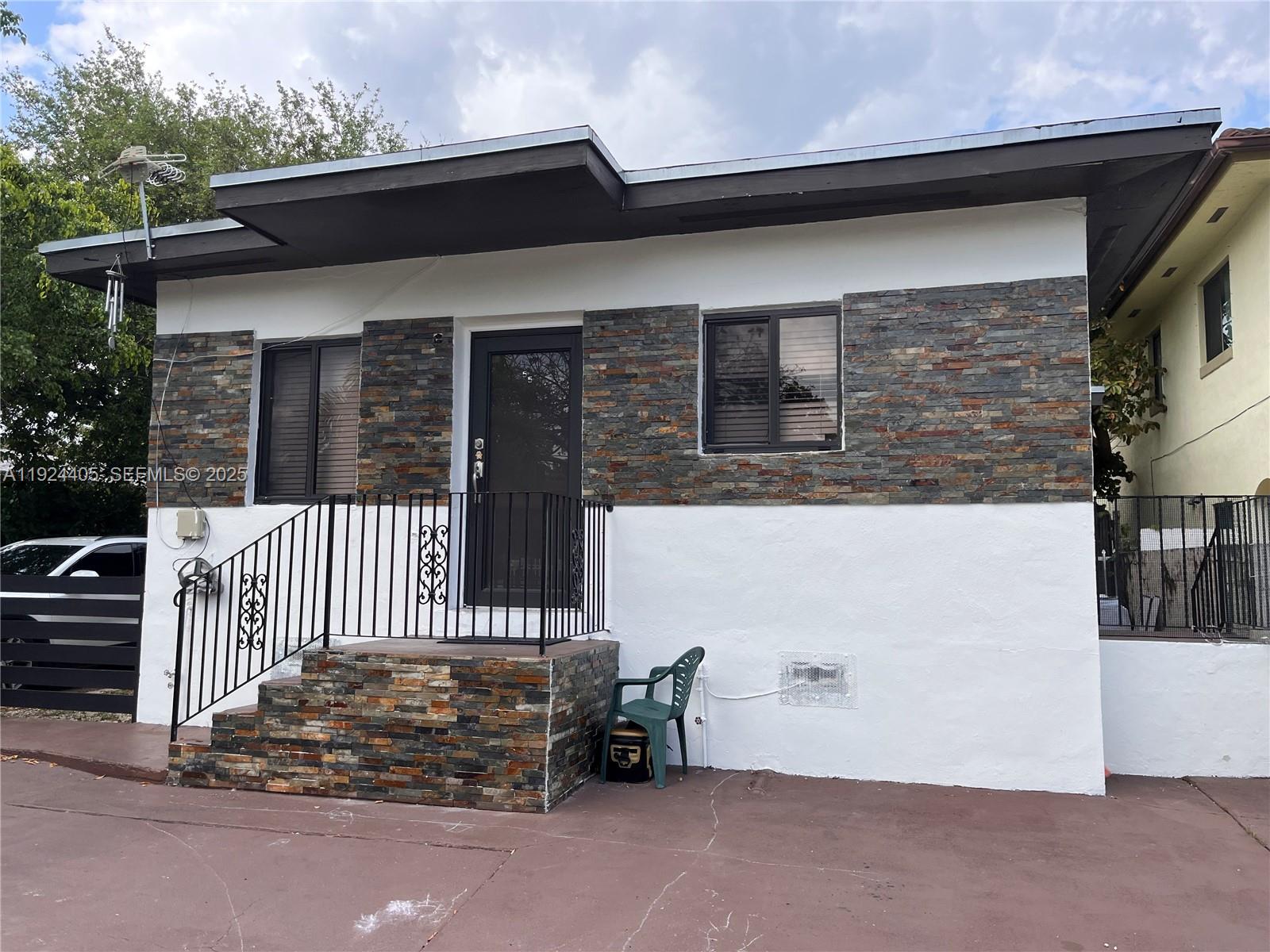 55 Northwest 44th Street Miami, FL 33127 - Photo 12 of 22 a view of a house with wooden fence