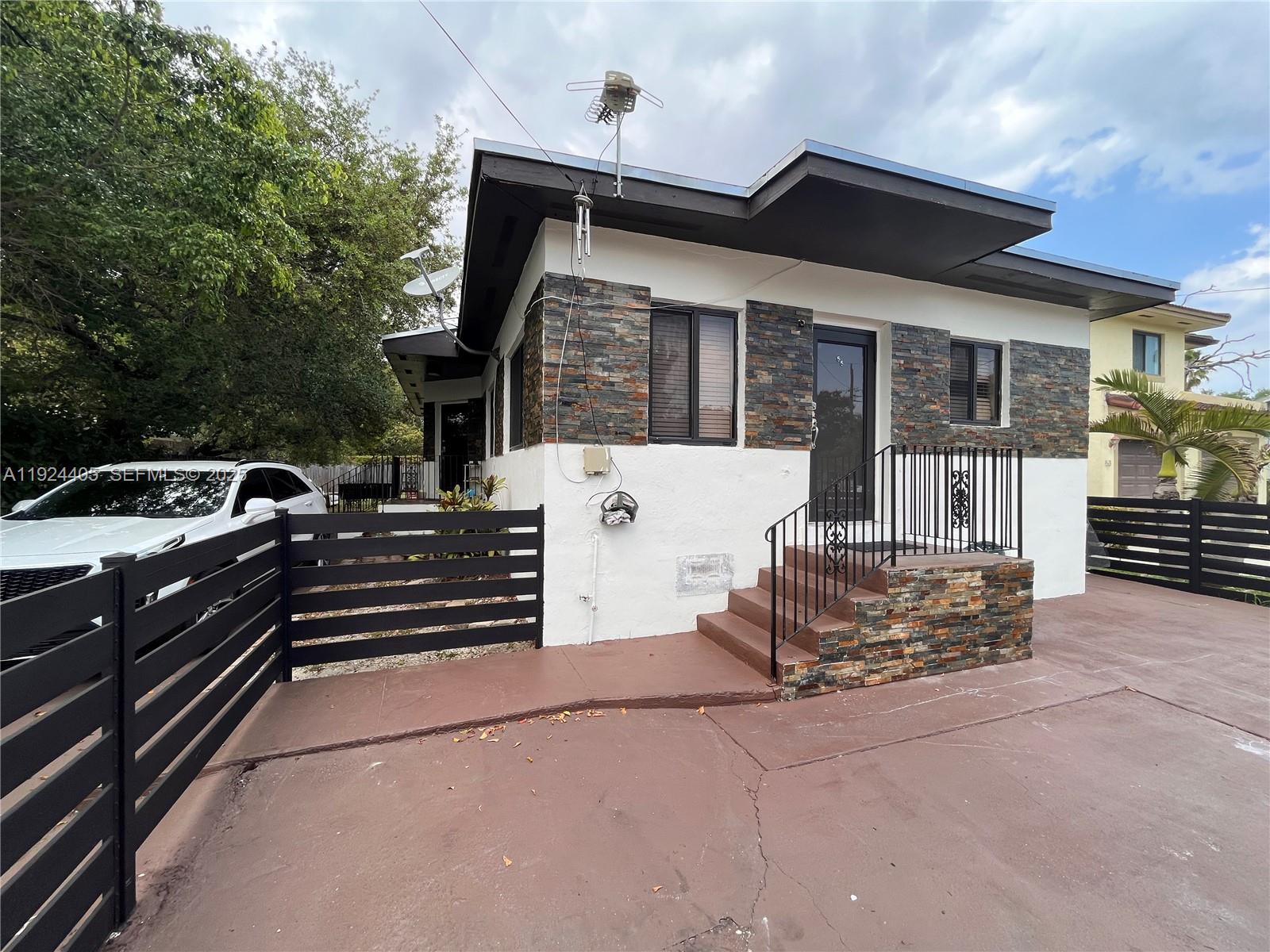 55 Northwest 44th Street Miami, FL 33127 - Photo 13 of 22 a front view of a house with a garage
