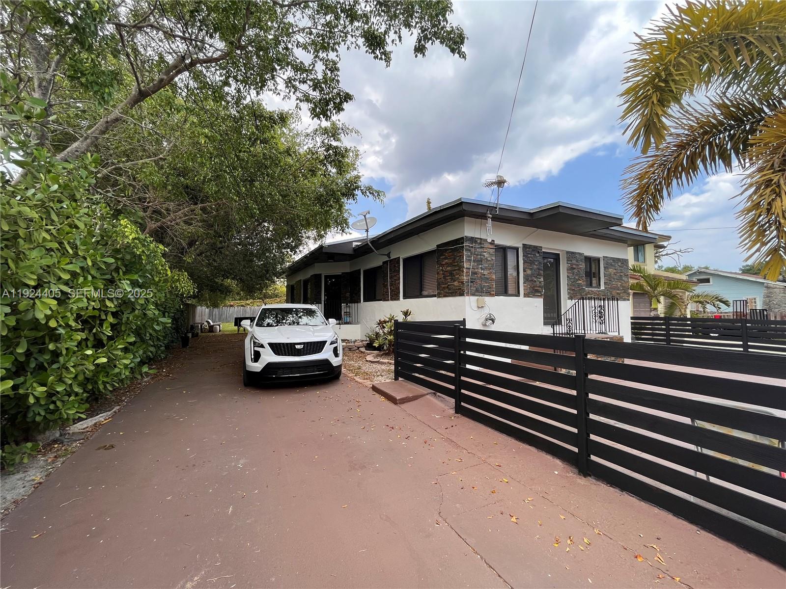 55 Northwest 44th Street Miami, FL 33127 - Photo 16 of 22 a front view of a house with a garden