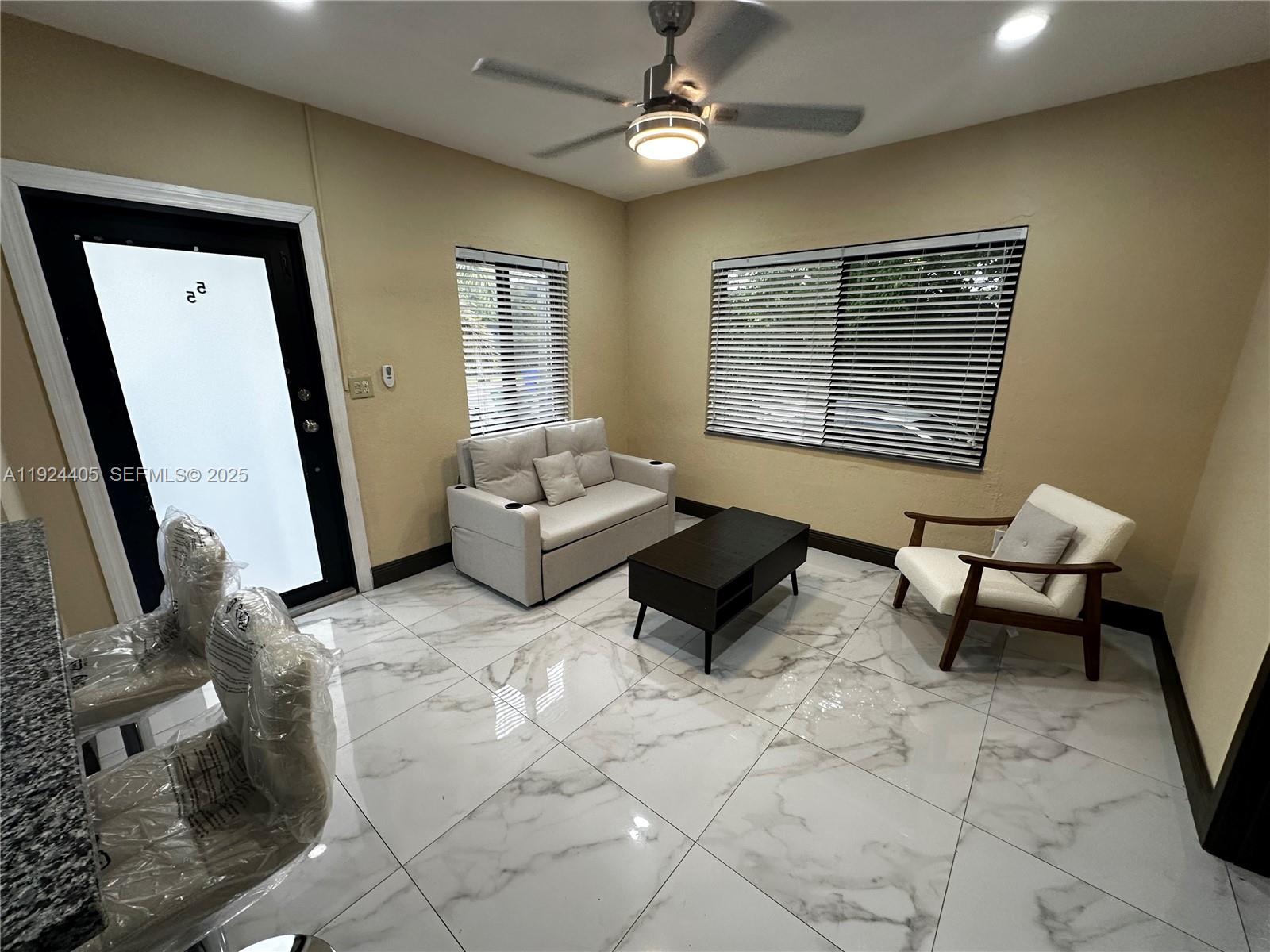 55 Northwest 44th Street Miami, FL 33127 - Photo 5 of 22 a living room with furniture and a window