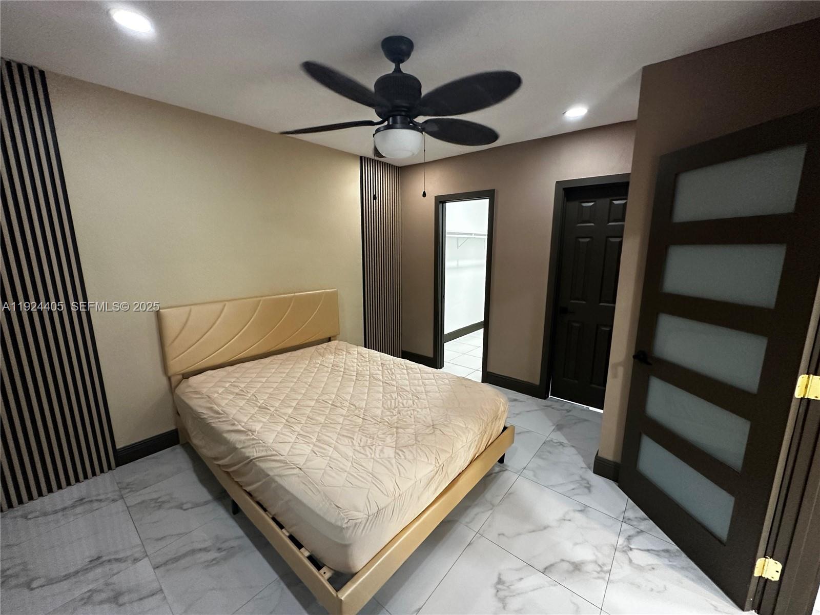 55 Northwest 44th Street Miami, FL 33127 - Photo 7 of 22 a bedroom with a bed and a large mirror