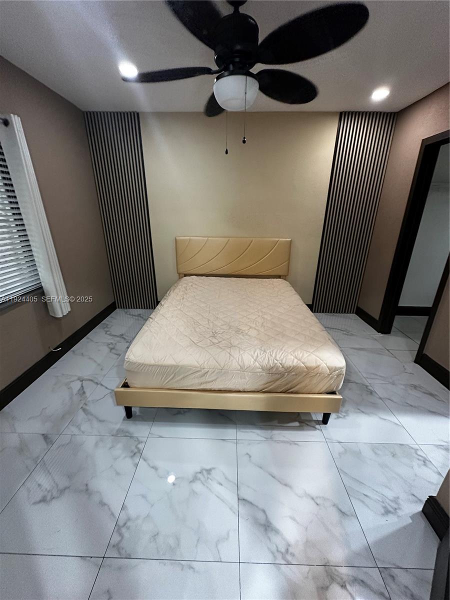 55 Northwest 44th Street Miami, FL 33127 - Photo 8 of 22 a bedroom with a bed and a walk in closet