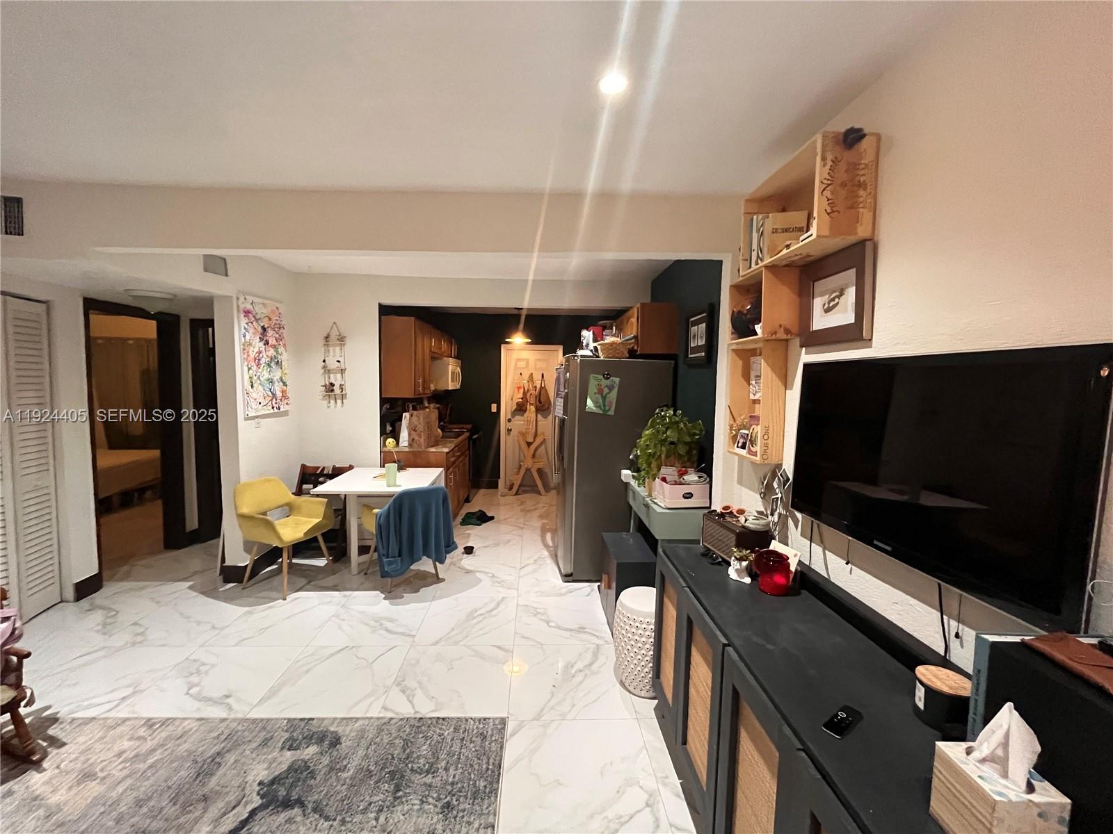 55 Northwest 44th Street Miami, FL 33127 - Photo 9 of 22 a living room with furniture and a flat screen tv