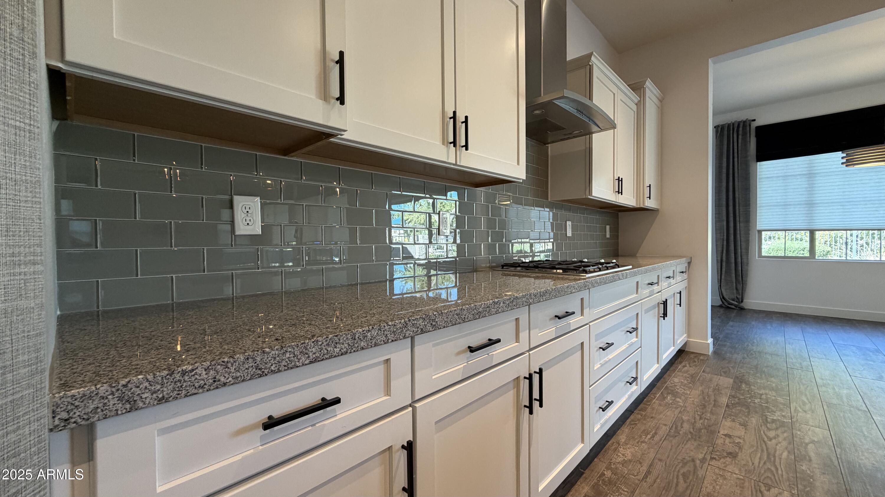 4536 East Walter Way Phoenix, AZ 85050 - Photo 11 of 50 a kitchen with granite countertop white cabinets and white appliances