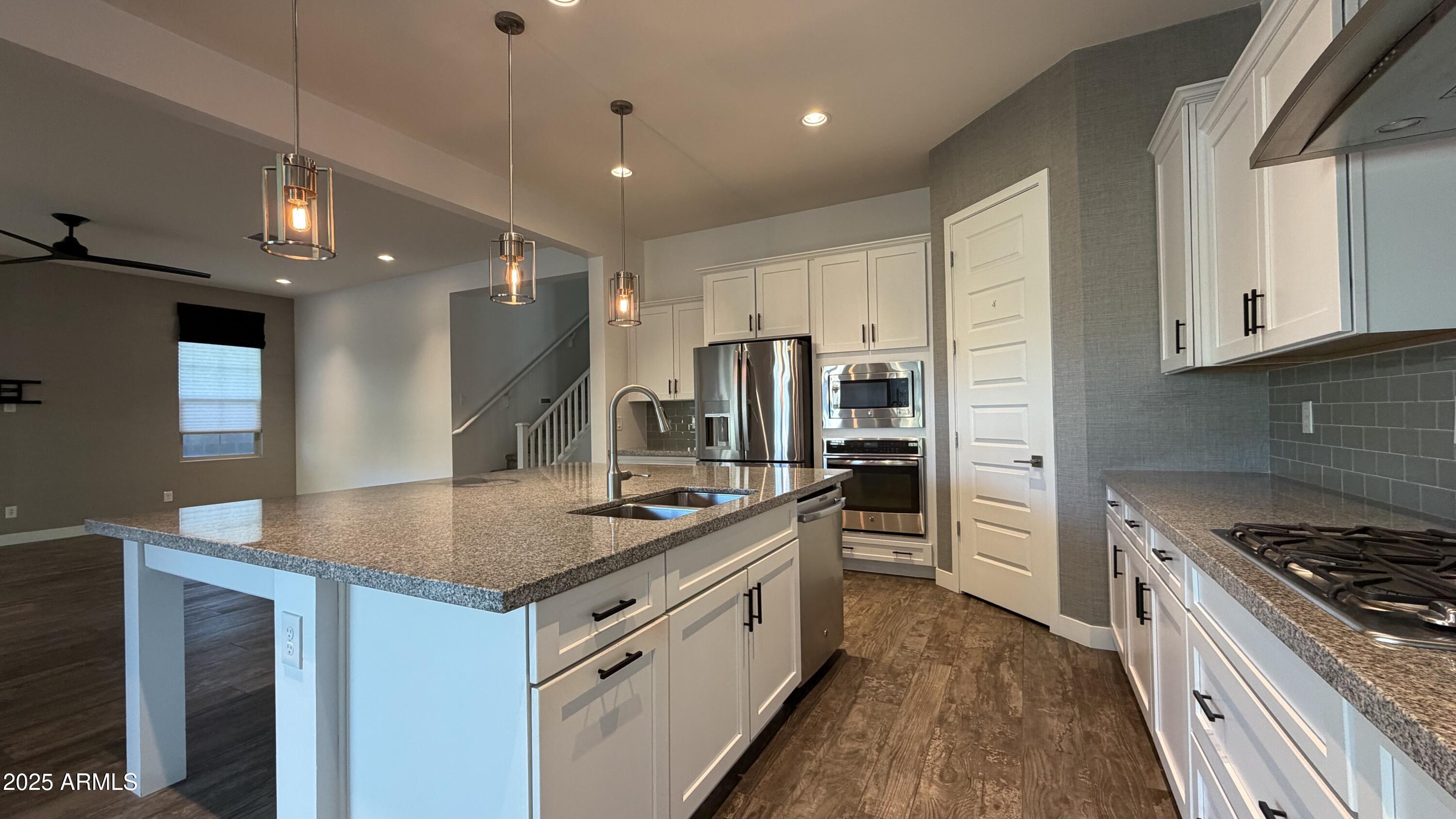 4536 East Walter Way Phoenix, AZ 85050 - Photo 12 of 50 a kitchen with stainless steel appliances granite countertop a stove and a refrigerator