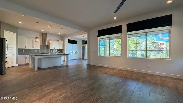 a large kitchen with stainless steel appliances granite countertop a stove and a large window