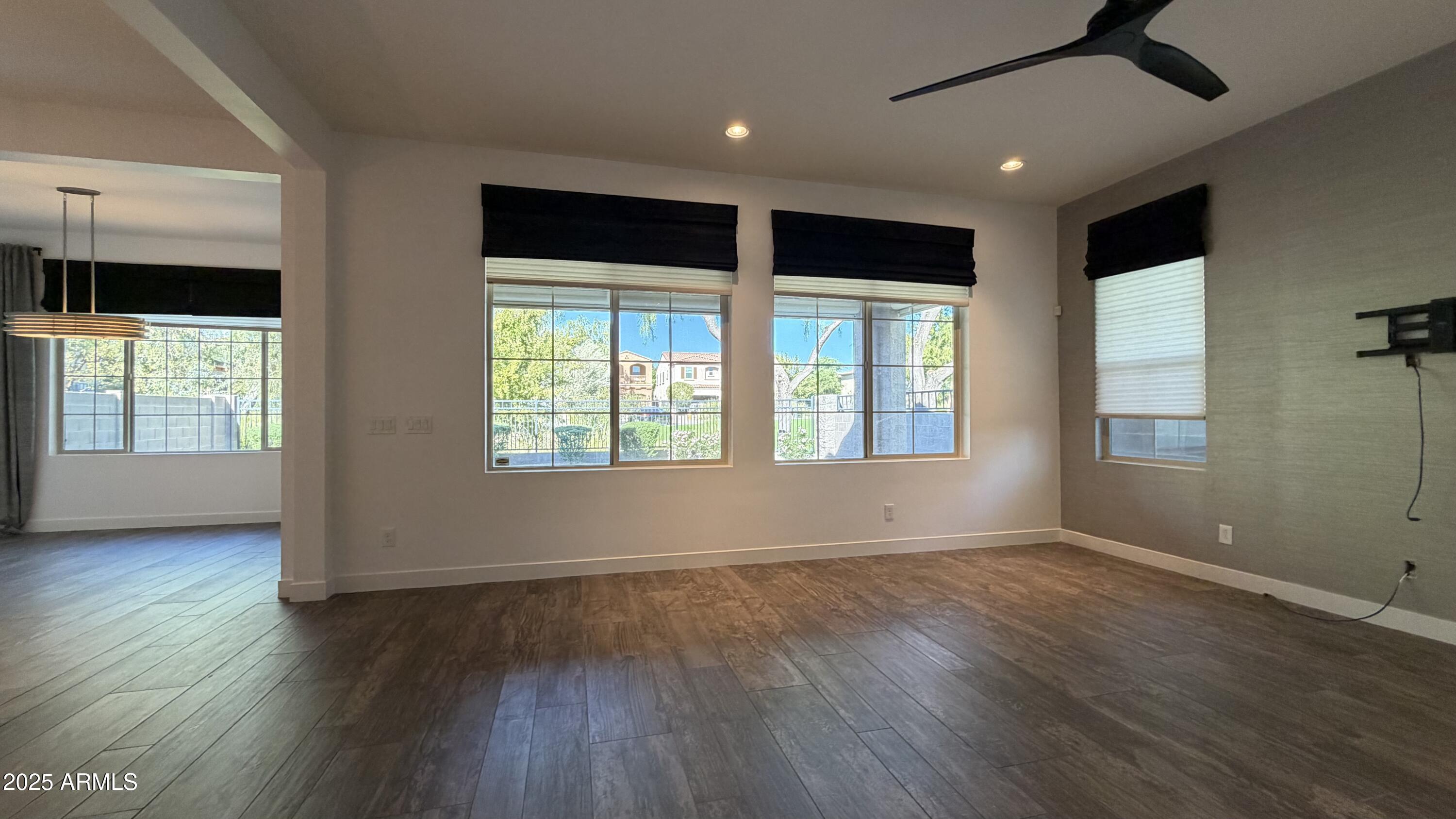 4536 East Walter Way Phoenix, AZ 85050 - Photo 15 of 50 a view of an empty room with wooden floor and a window
