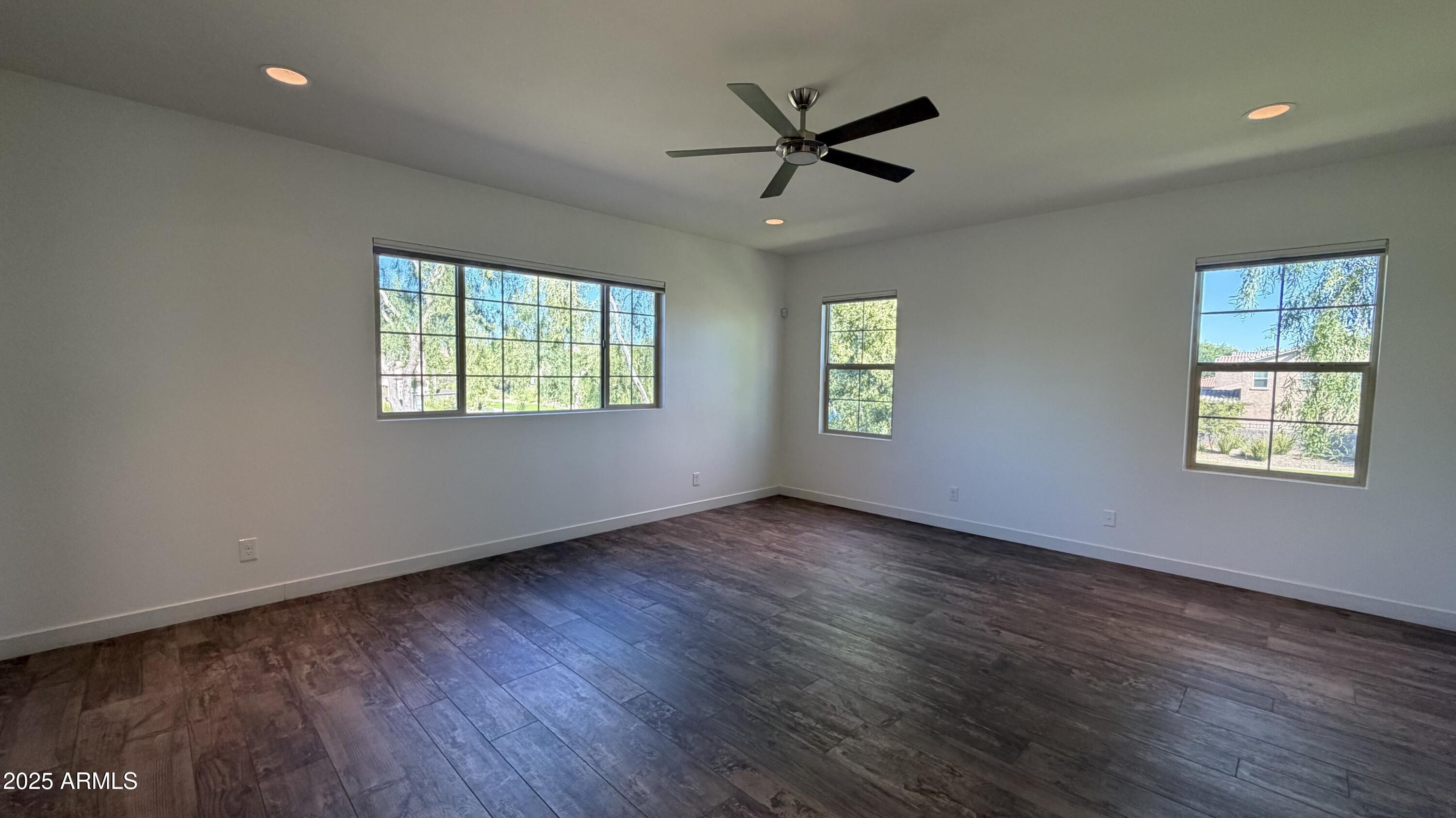4536 East Walter Way Phoenix, AZ 85050 - Photo 19 of 50 a view of an empty room with wooden floor and a window