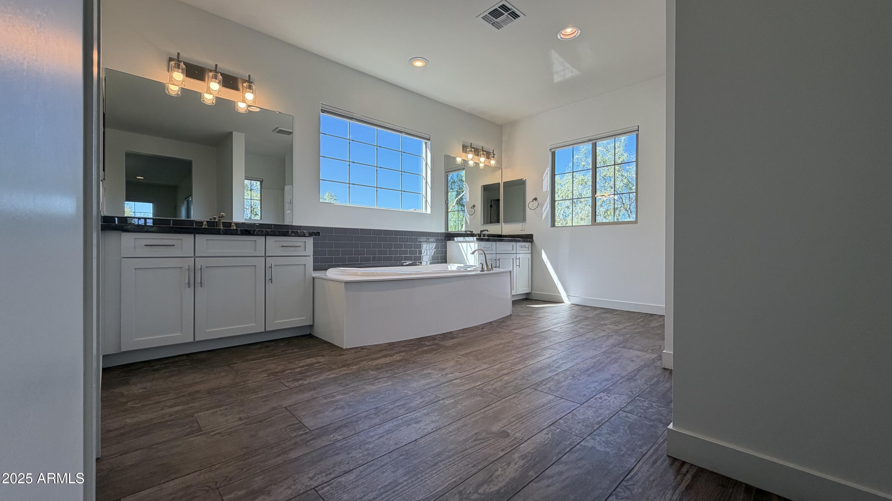 4536 East Walter Way Phoenix, AZ 85050 - Photo 23 of 50 a large white kitchen with wooden floor