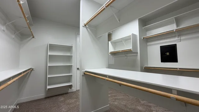 a view of walk in closet with empty racks